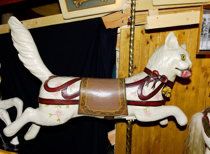 A cat dozes on a stationary merry go round